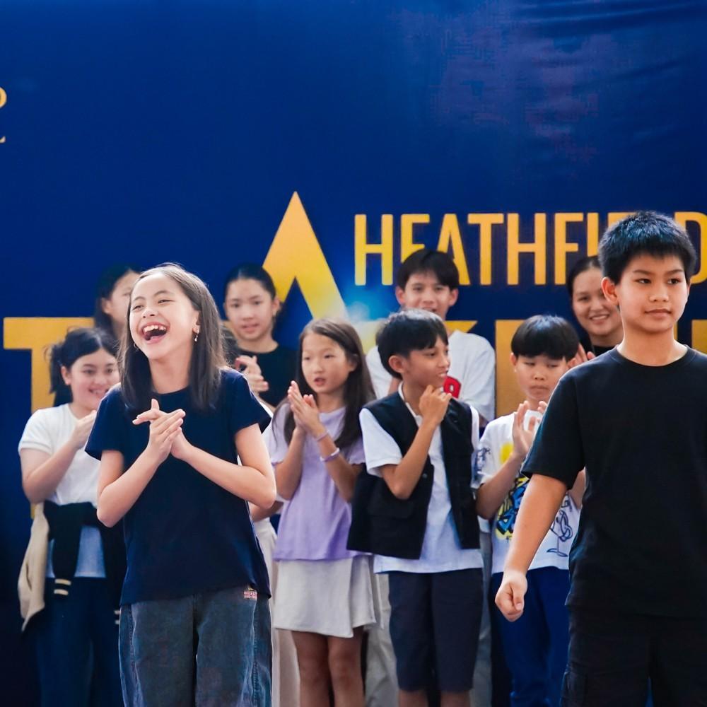 Large group of students applaud each other after a successful show.