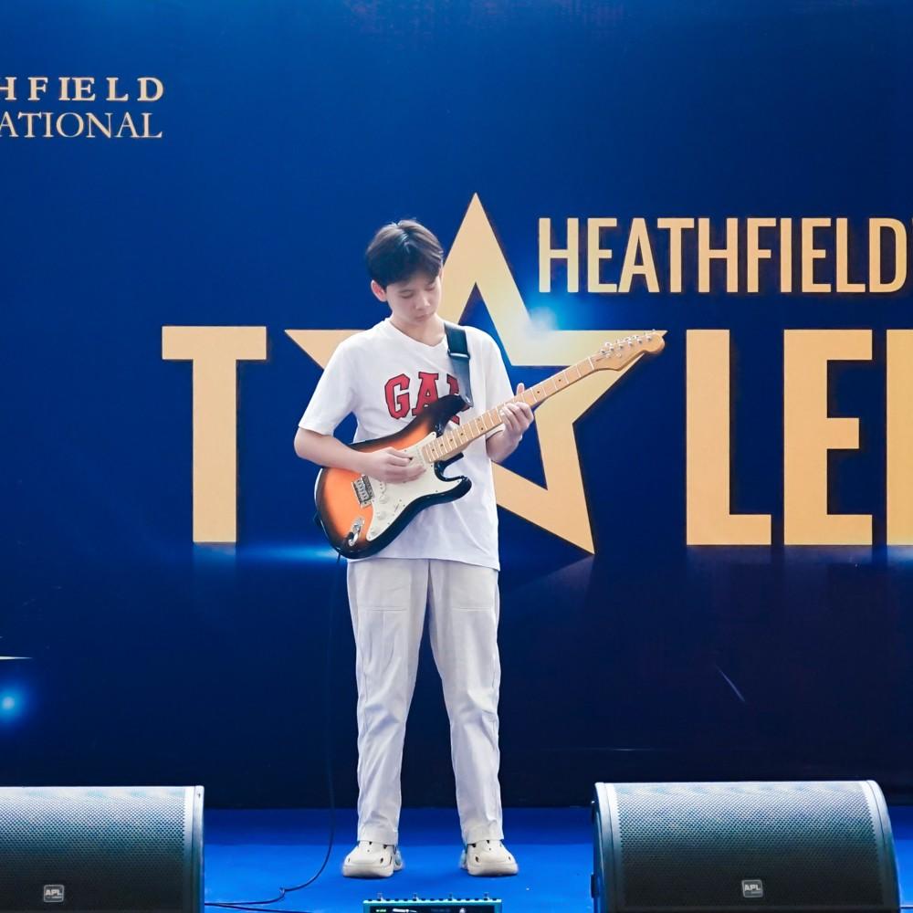 Student performs a solo electric guitar piece on stage at Heathfield's Got Talent.