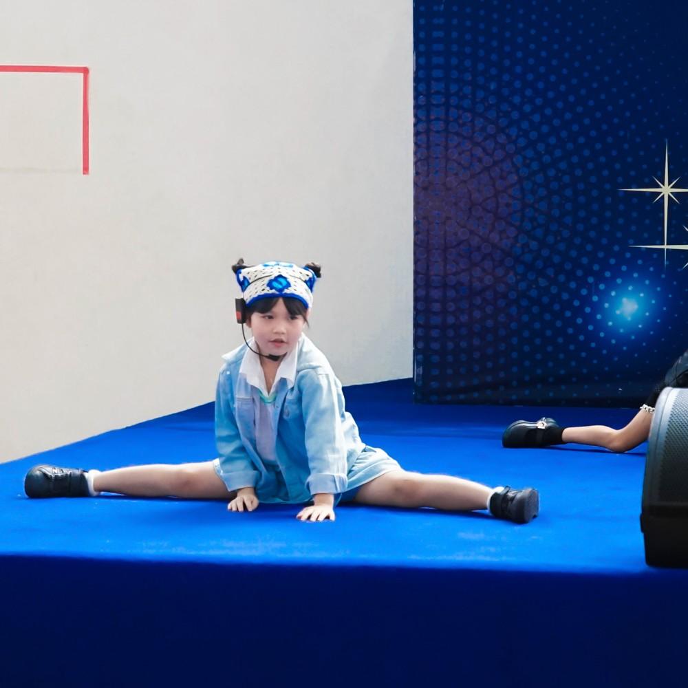 Young performer demonstrates flexibility during a dance routine.