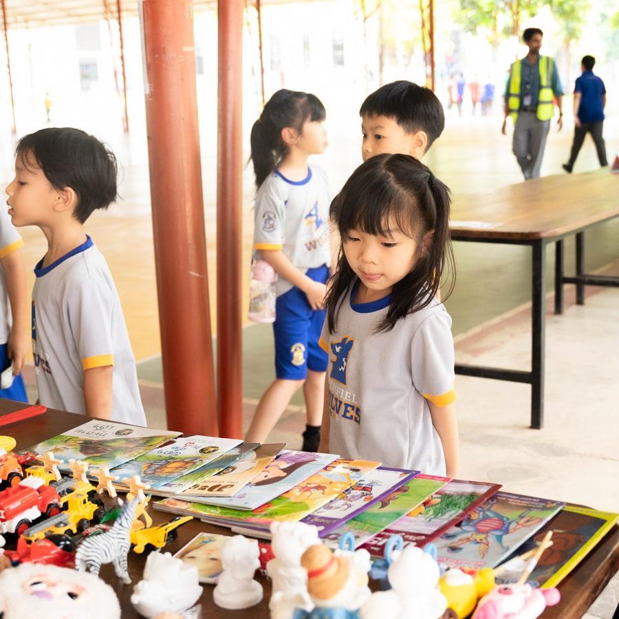 Young student looking at books for sale