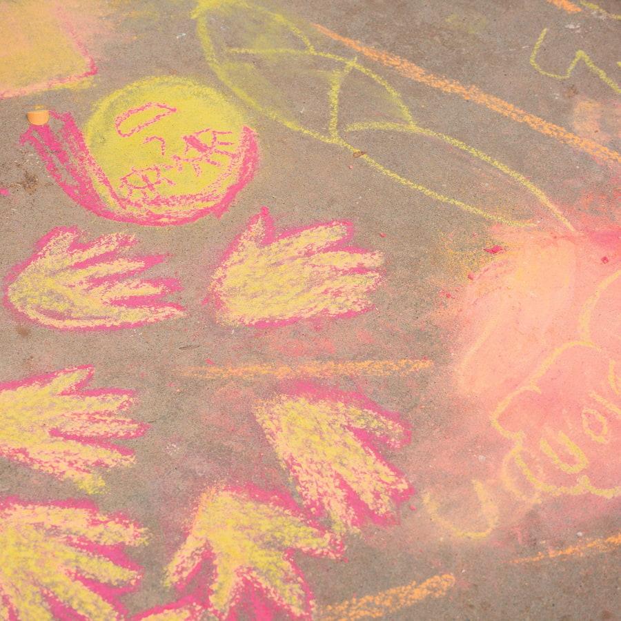 Student artwork drawn on the sidewalk with chalk