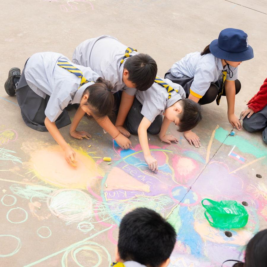 Students working on chalk art for inclusion week