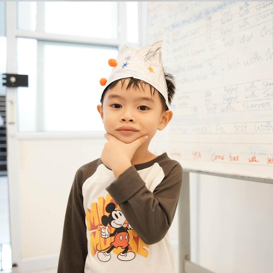 Young student wearing paper crown