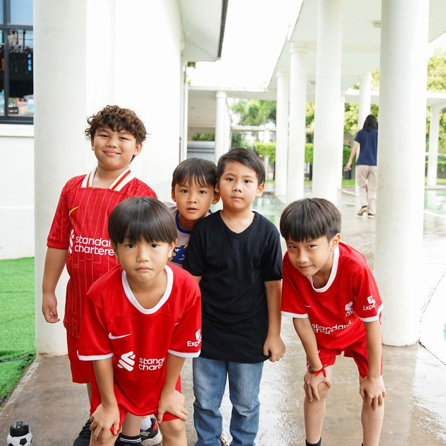 Five students wearing athletic clothing