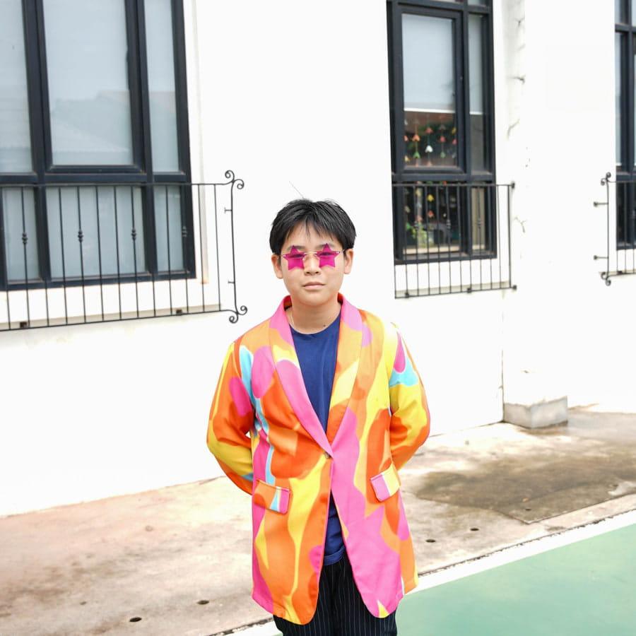 Student wearing a colorful blazer and sunglasses