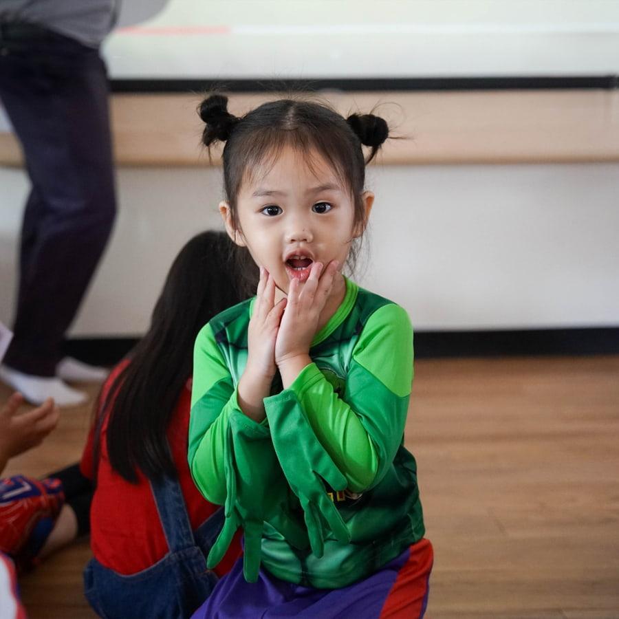 Young student wearing green costume