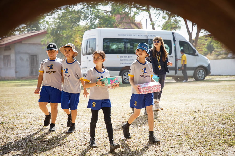 Children delivering boxes during holiday box project event.